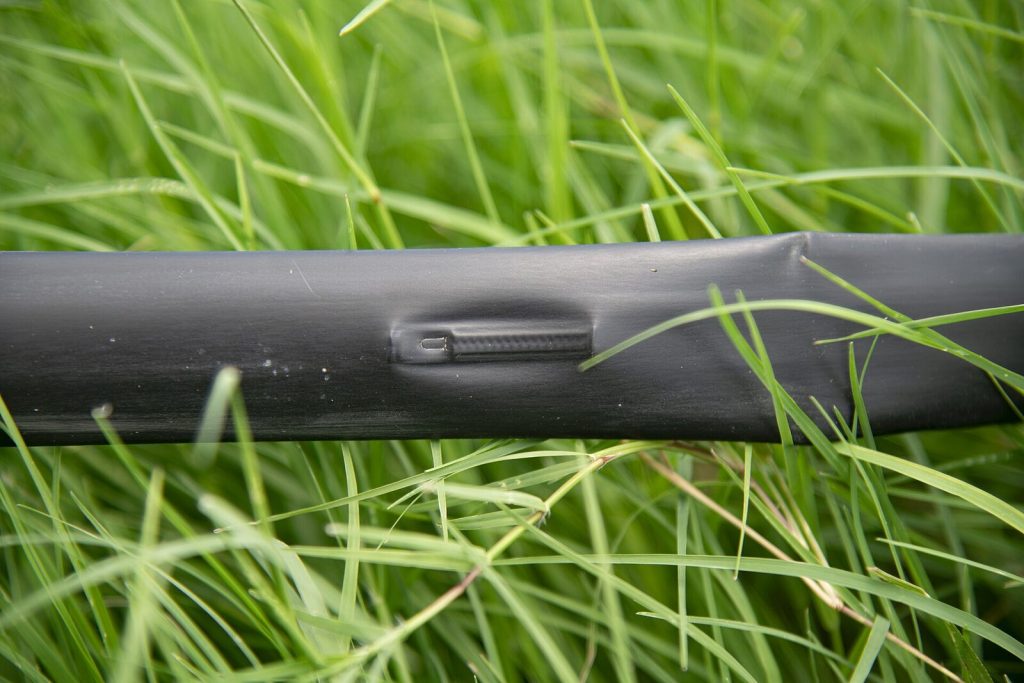 Drip irrigation tape running along a crop row
