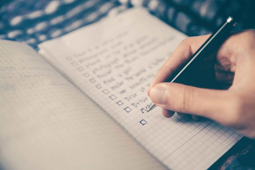 Figures written up by hand in a ruled notebook